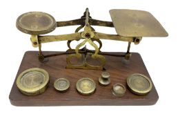 Brass postage scales on rectangular wooden base