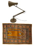 Angle-poise lamp and an Islamic prayer mat