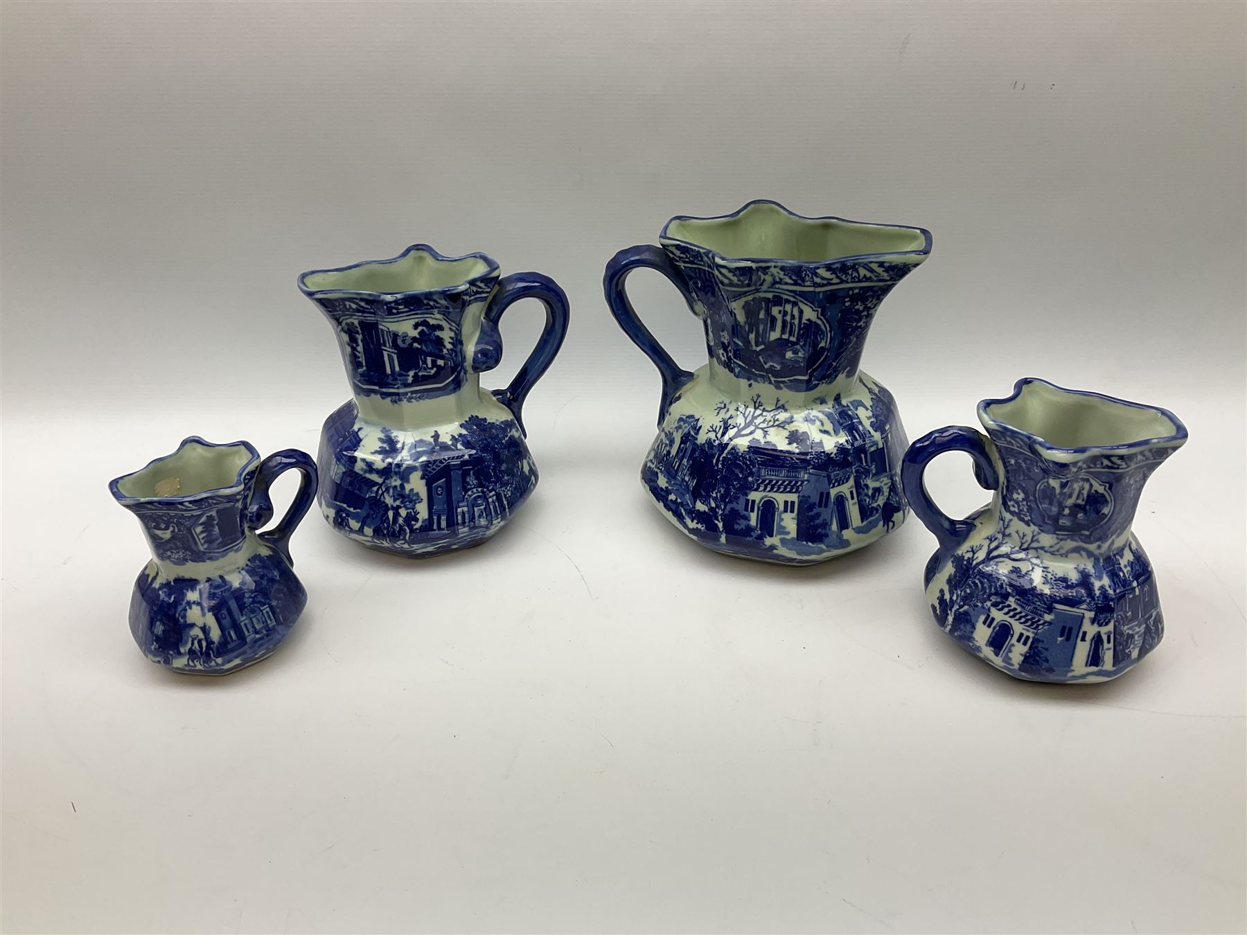 Set of four blue and white ironstone graduated jugs decorated with town scenes - Image 3 of 6