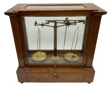 Set of brass balance scales in glazed mahogany case