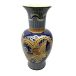 Oriental crackle glaze floor vase decorated with a dragon upon a blue ground