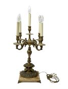 French style gilt metal four branched candelabra supported by fawns and upon a rectangular lion claw