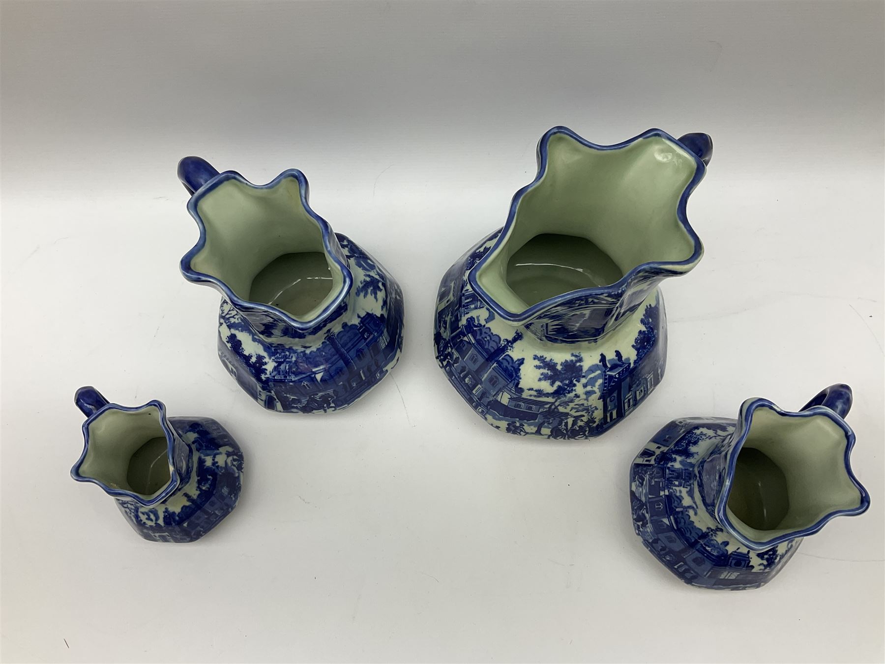 Set of four blue and white ironstone graduated jugs decorated with town scenes - Image 2 of 6