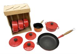 Le Creuset 'Volcanic Orange' cast iron and enamel milk pan with wood handle together with a three pi