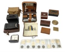 Gents leather cased travelling toilet set and cased brushes; two cameras; roll of drawing instrument