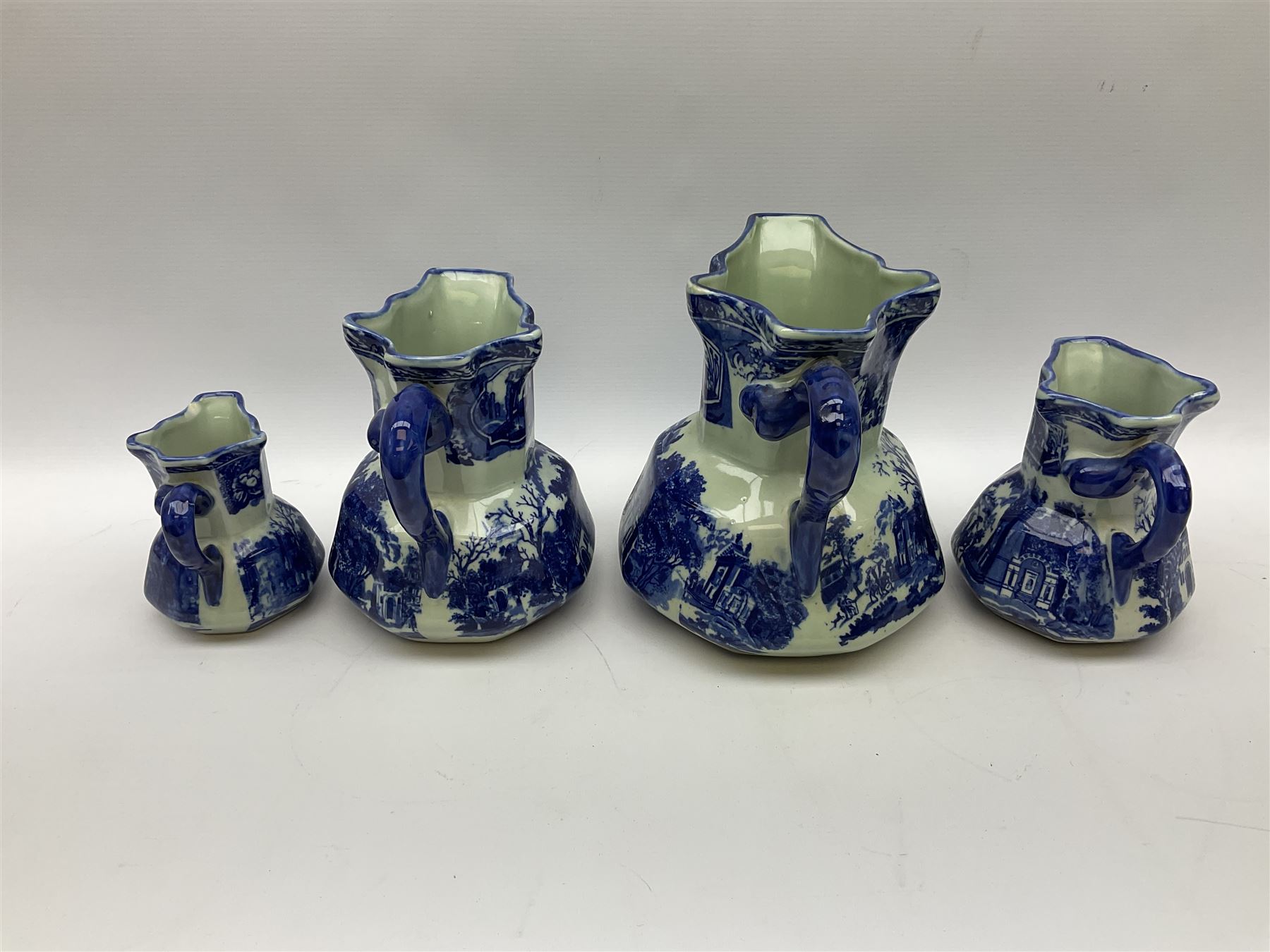 Set of four blue and white ironstone graduated jugs decorated with town scenes - Image 4 of 6