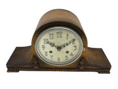 An oak cased 1930's Tambour mantle clock with carved decoration raised on four feet