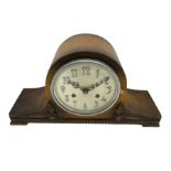 An oak cased 1930's Tambour mantle clock with carved decoration raised on four feet