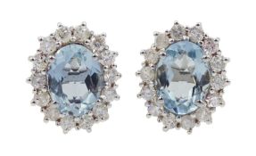 Pair of 18ct white gold oval aquamarine and diamond cluster stud earrings