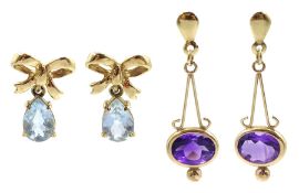 Pair of gold oval amethyst pendant stud earrings and a pair of gold blue topaz bow pendant stud earr