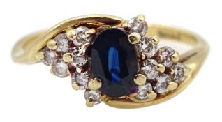 Gold oval sapphire and diamond crossover cluster ring