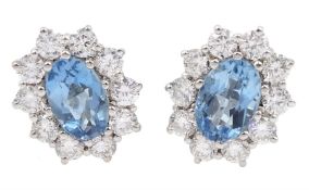 Pair of 18ct white gold oval aquamarine and round brilliant cut diamond cluster stud earrings