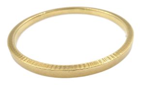 Early 20th century large 9ct gold bangle with engine turned decoration