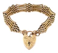 Early 20th century rose gold gate bracelet with engraved heart locket clasp