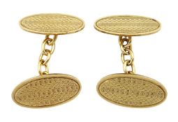 Pair of early 20th century 9ct gold oval engine turned decoration cufflinks