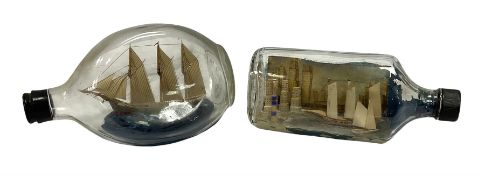 Two ships in bottles with painted seascape and city detail