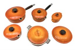 Le Creuset 'Volcanic Orange' cast iron and enamel saucepans and two lidded casserole dishes