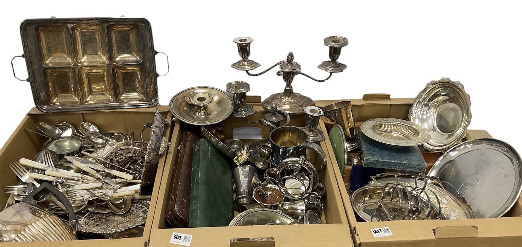 Three boxes of silver plate to include pair of candelabras