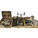 Three boxes of silver plate to include pair of candelabras