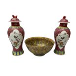 Pair of oriental famille rose vases of a baluster form with foo dog decoration on covers