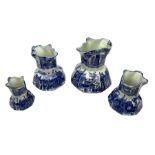 Set of four blue and white ironstone graduated jugs decorated with town scenes