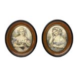 Pair of oval walnut frames with ebonised border