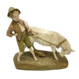 Royal Dux figure modelled as a young boy holding a bull on naturalistic base