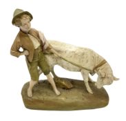 Royal Dux figure modelled as a young boy holding a bull on naturalistic base