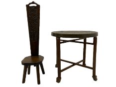 Carved oak spinning chair and a Benares folding brass top table