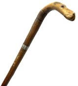 Walking stick with carved wooden handle modelled as the head of a hound with inset glass eyes