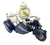 Cast iron figure of Michelin Man on motorbike modelled with smaller seated Michelin man in sidecar