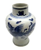 Chinese blue and white vase of baluster form painted with phoenix amongst auspicious clouds