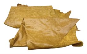 Two pieces of tan leather hide