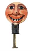 Early to mid 20th Century mechanical hand held toy with push-activated sparking eyes and mouth