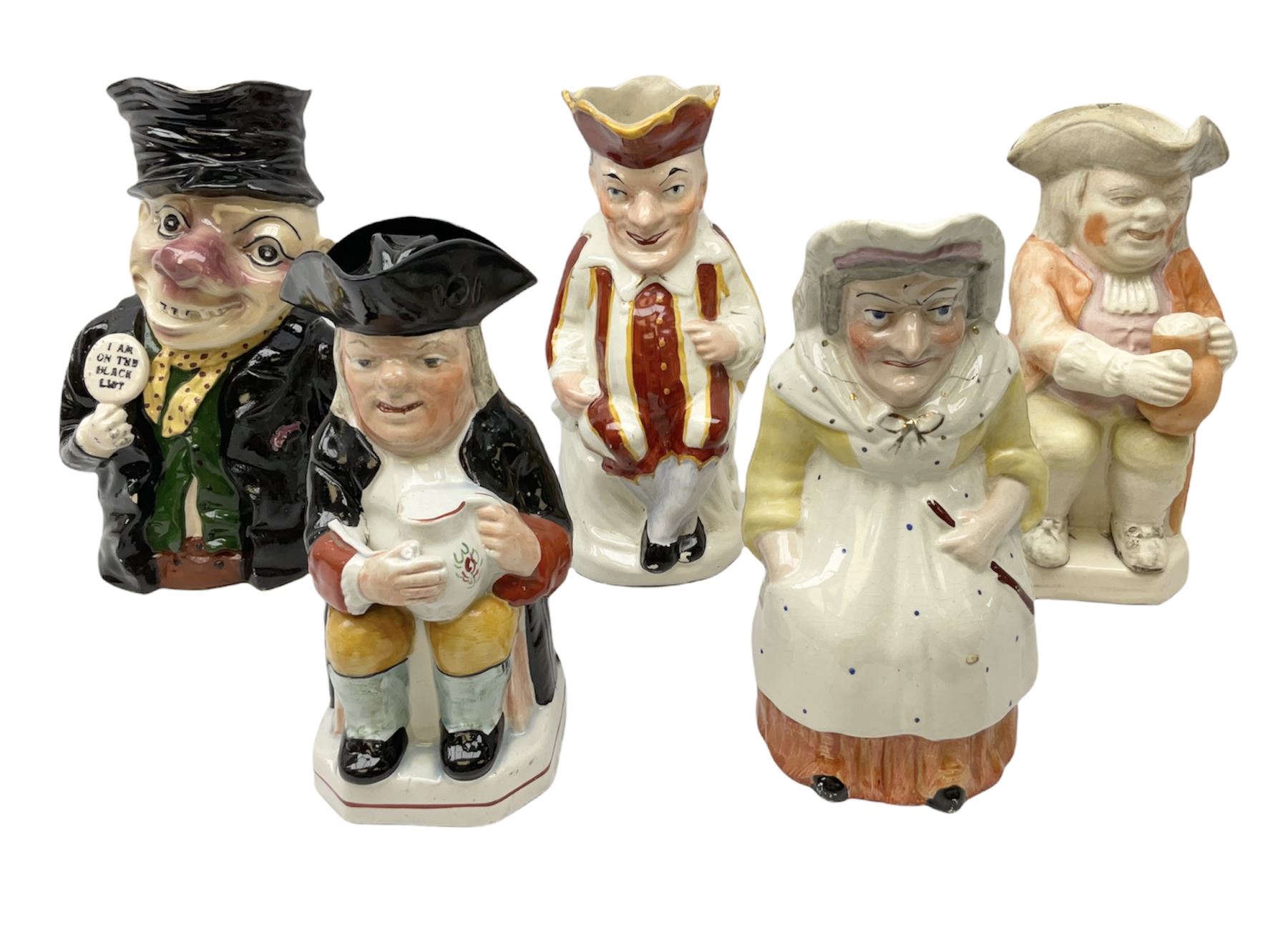 19th century and later Toby jugs comprising Staffordshire Punch and Judy jugs