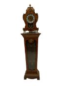 A contemporary 20th century Boulle clock case on a conforming tapered plinth with a glazed door supp