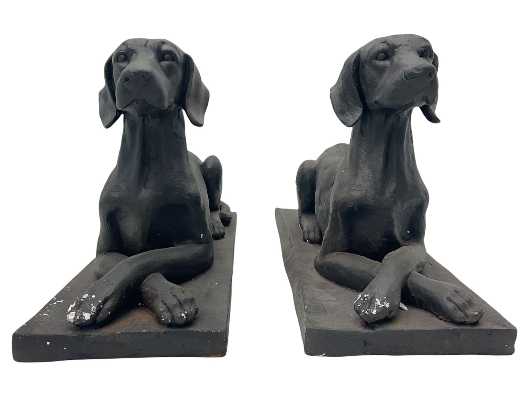 Pair of composite recumbent Labrador figures
