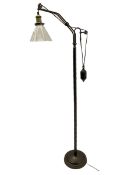 Industrial floor lamp in matte bronze finish with adjustable cantilever head