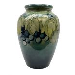 Moorcroft Grape and Leaf pattern baluster vase on green and blue ground