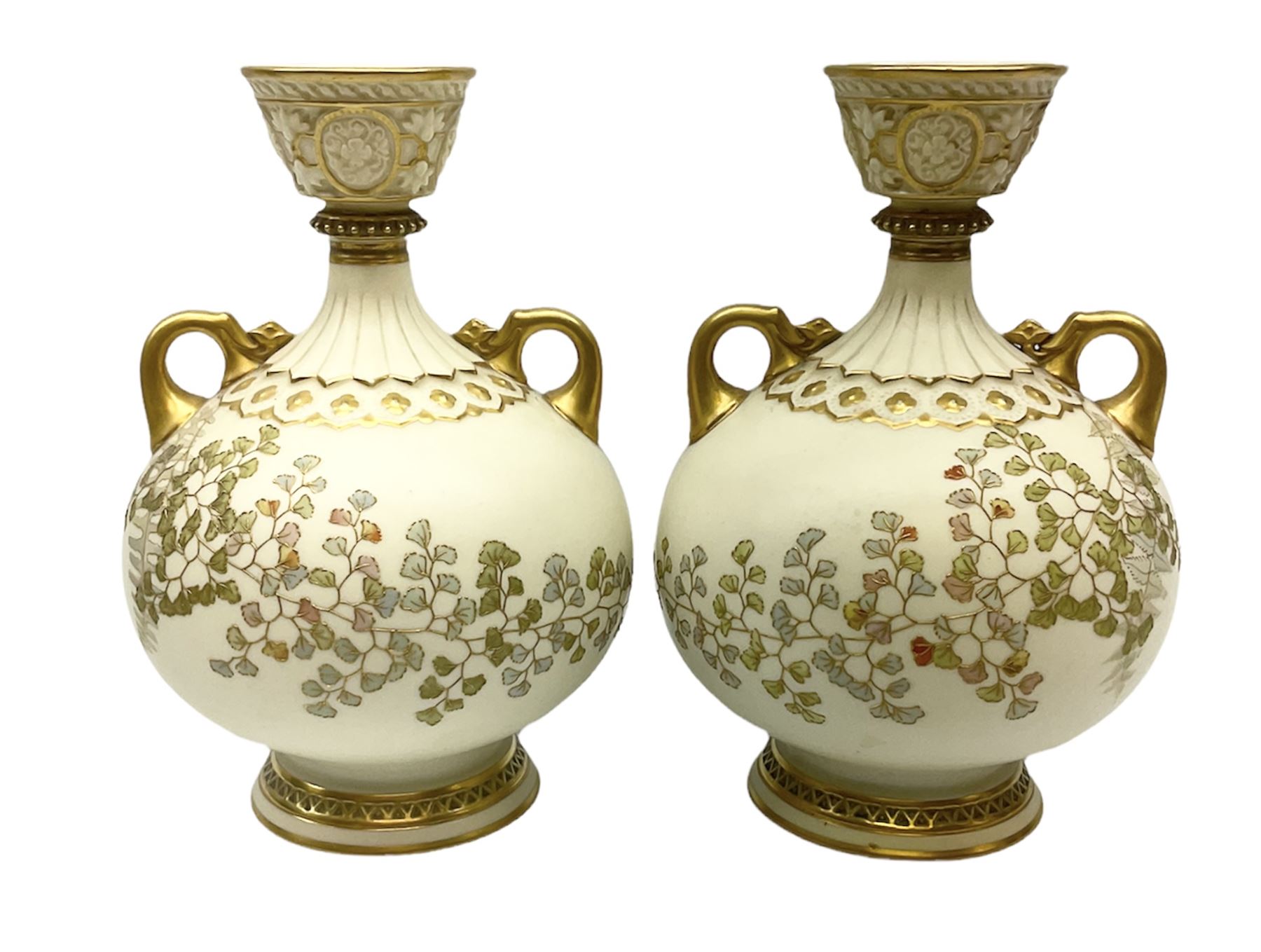 Pair of Royal Worcester ivory twin handled vases of baluster form