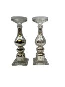 Pair of glass candlesticks with shaped columns decorated with internal silver flaked silver design