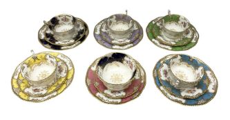 Five Coalport trios decorated in floral sprays with gilt in various colours