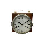 A compact German manufactured ships clock in a spun brass case with a 5" dial within a flat bevelled