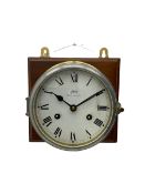 A compact German manufactured ships clock in a spun brass case with a 5" dial within a flat bevelled