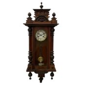 A late 19th century German wall clock with an 8-day spring driven movement striking the hours on a c