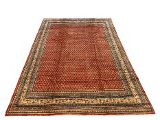 Large Persian Arak red ground carpet