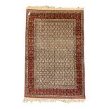 Fine Persian beige and red ground rug