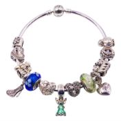 Pandora silver bracelet with a Disney Tinker Bell charm and twelve other Pandora charms