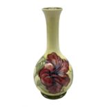 Moorcroft Hibiscus pattern vase of fluted form on a yellow ground