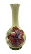 Moorcroft Hibiscus pattern vase of fluted form on a yellow ground